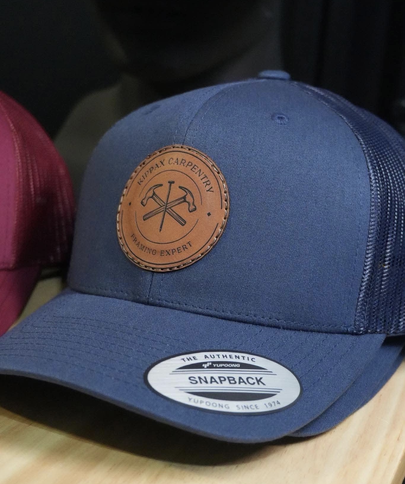 Kippax Carpentry snapback hat navy leather patch